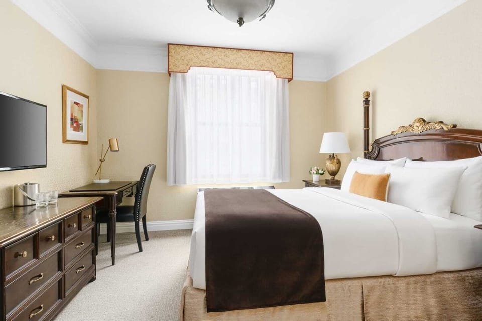 Recharge in a serene king room with practical storage.