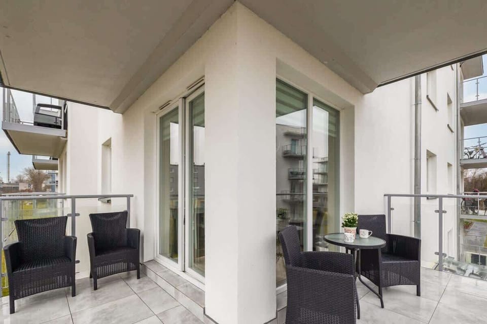 A second look at the spacious balcony, with comfortable outdoor seating and a great view of the surrounding buildings.

