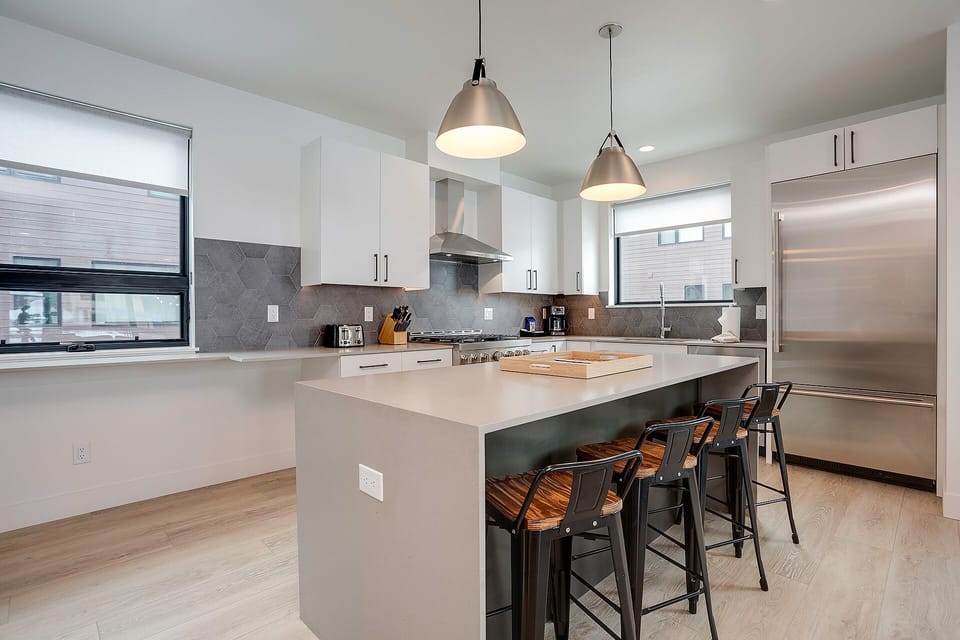Cook your favorite meals in this sleek modern kitchen with stainless steel appliances and a spacious island for gathering.