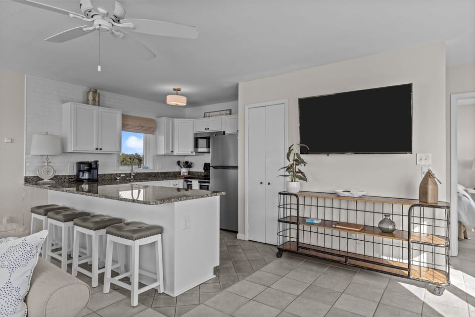 Relax in your modern open-concept space with a fully equipped kitchen, granite counters, and comfortable seating for cooking and entertainment.