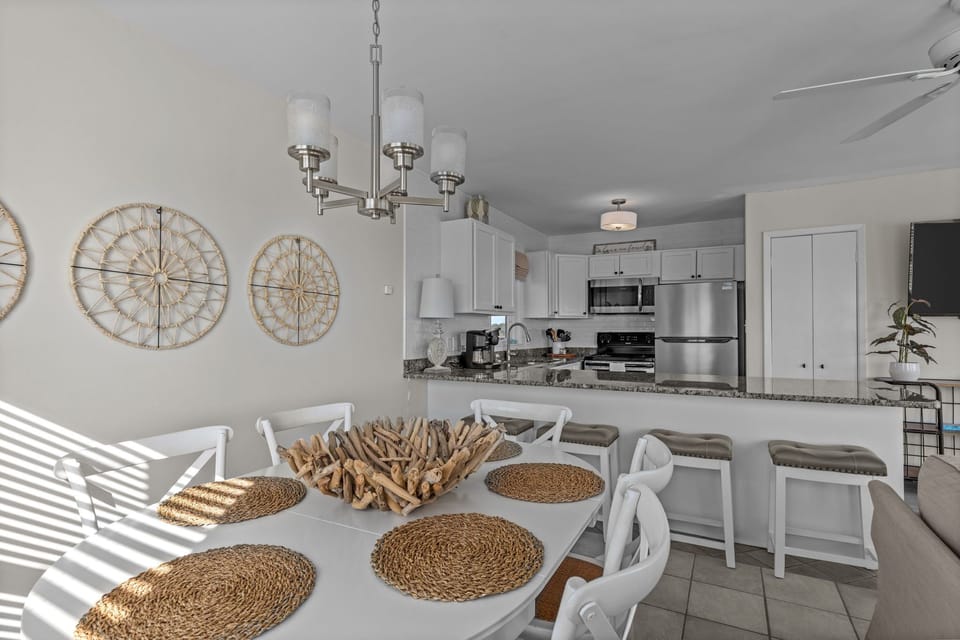Gather around this bright dining space where coastal charm meets modern comfort, perfect for sharing memorable meals together.