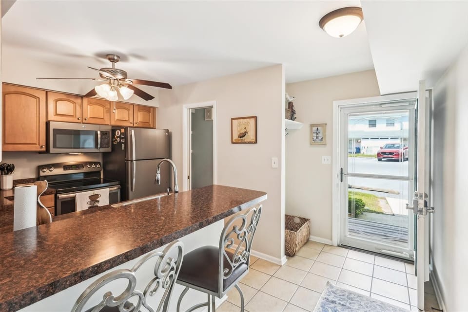 A welcoming kitchen where you can whip up your favorite meals at the granite-topped island, with modern appliances and plenty of storage at your fingertips.
