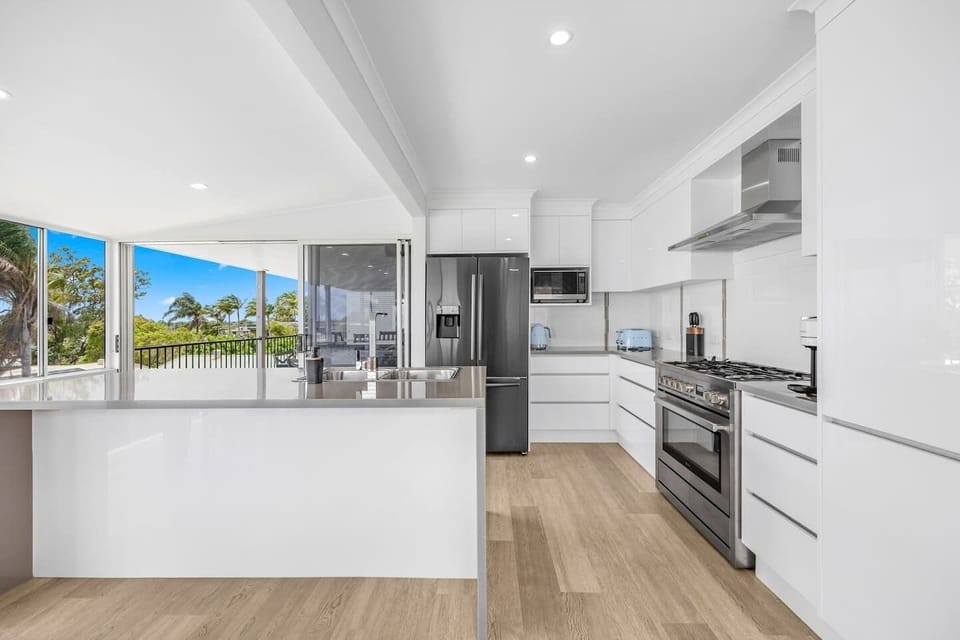 The sleek kitchen comes fully equipped for your holiday catering with modern appliances and cooking utensils.
