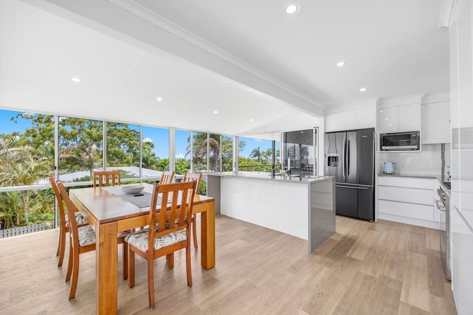 A large dining table inside creates ample space to come together for a shared meal at home.
