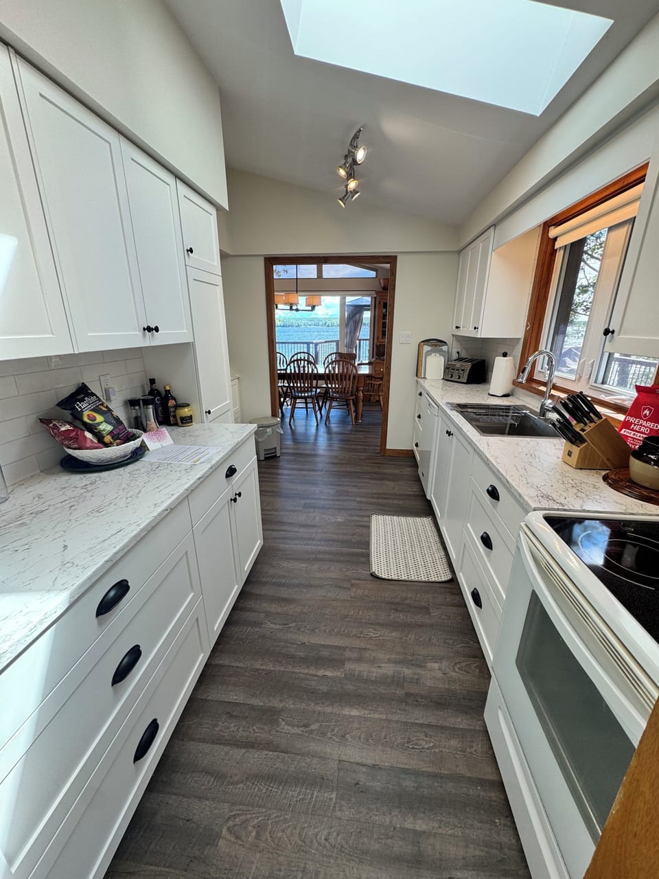 New bright kitchen with a wide range of cookware and pplateware and glassware