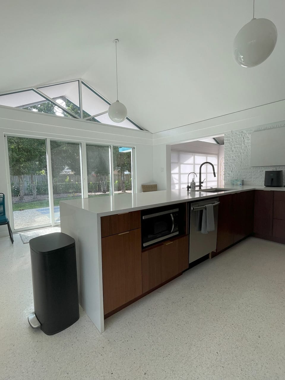 Kitchen showing sliders to backyard