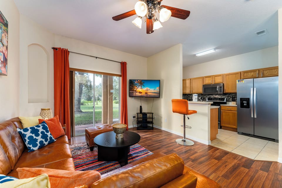 Living room showing TV, Breakfast Bar, and seating areas