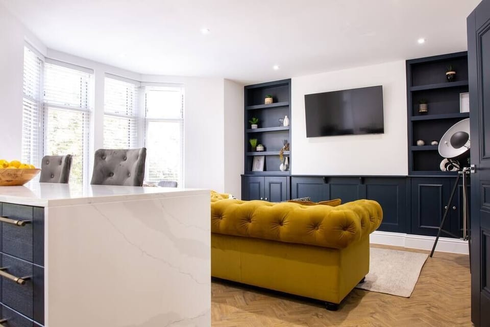 Living area with large yellow sofa.