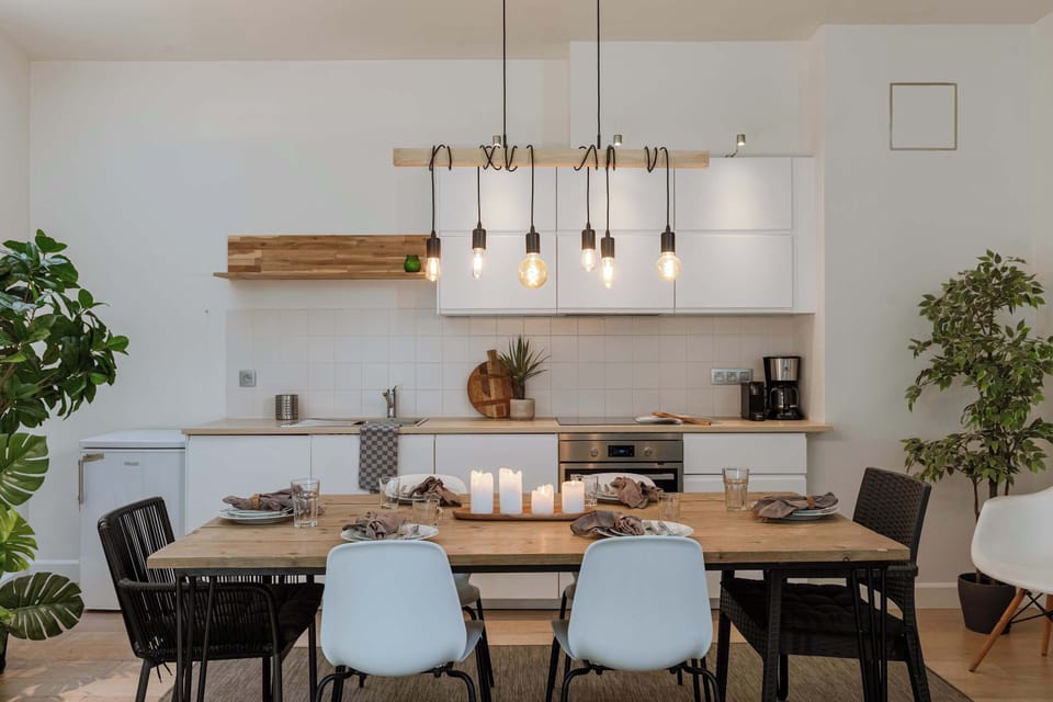 Elegant dining setup with statement lighting and cozy feel.