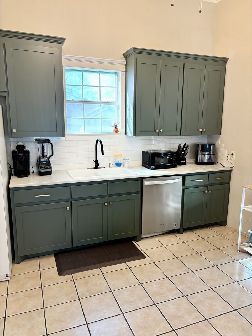 Kitchen is stocked with plates, cups, cookware, utensils.