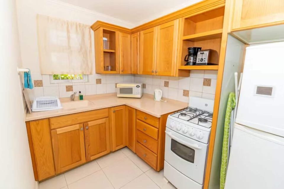 Cook easy meals with full stove, microwave, and ample cabinetry.