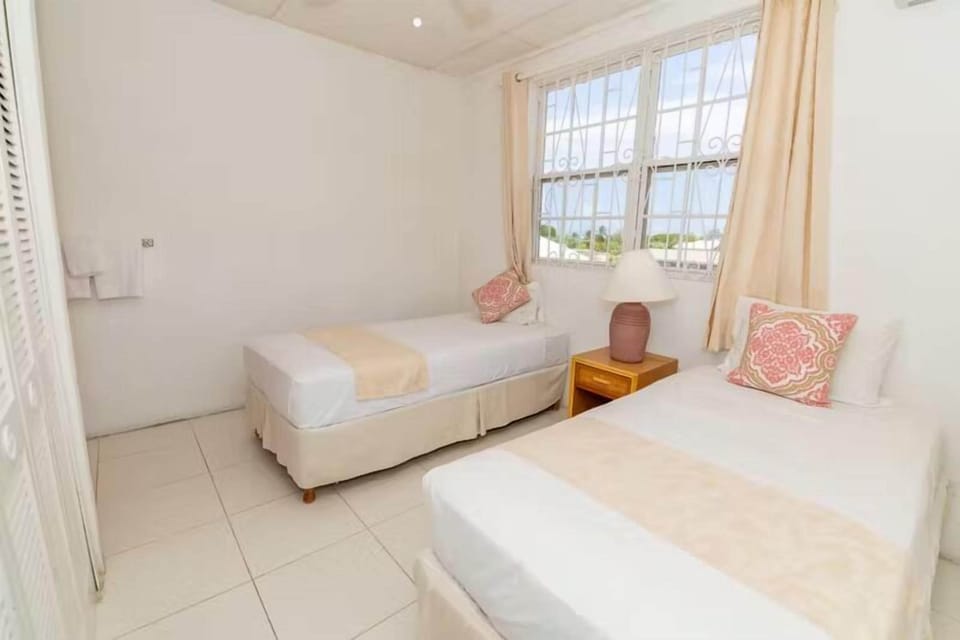 Wake gently to soft daylight in a calm, airy twin room.