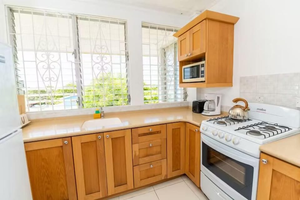 Start the day with coffee in a sunlit, full kitchen.
