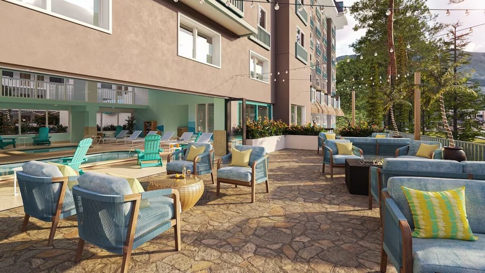 Unwind poolside on plush seating under warm afternoon sun.