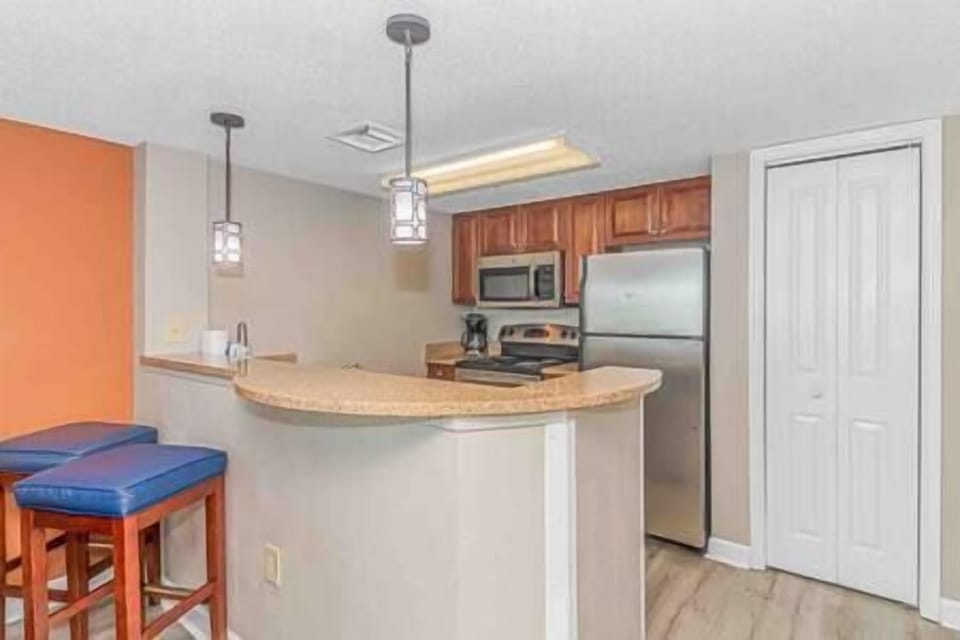 Kitchen featuring bar counter with seating for 2