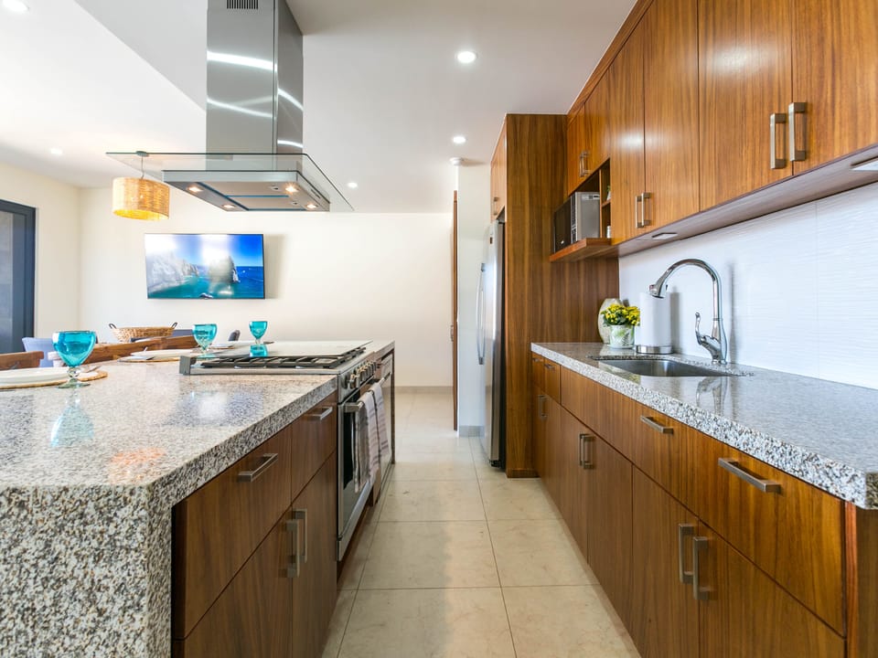 Step into the large, fully equipped kitchen and be inspired by its stunning ocean views. This spacious kitchen features modern appliances and ample counter space, making meal preparation a pleasure. Enjoy the breathtaking ocean panorama while cooking or dining, blending functionality with unparalleled beauty.