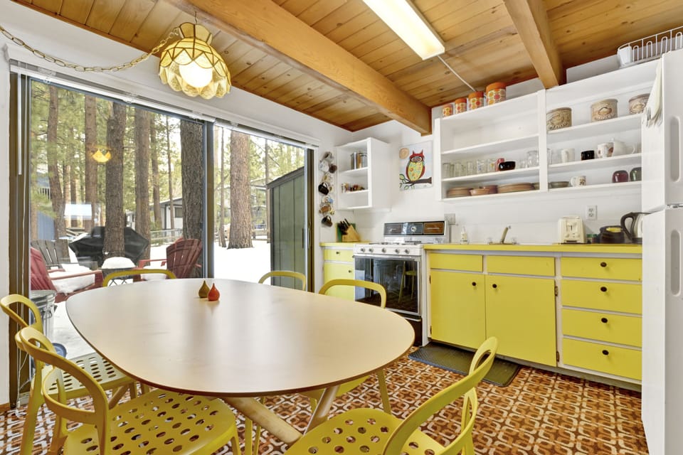 Fully equipped cabin kitchen with ample cabinetry, stove, fridge, microwave, and coffee maker—perfect for cooking meals, morning coffee, and feeling right at home on your stay.