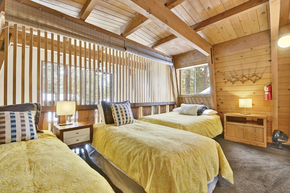 Peaceful cabin bedroom with plush bedding, and beautiful views—ideal for restful nights, cozy mornings, and a relaxing mountain escape.
