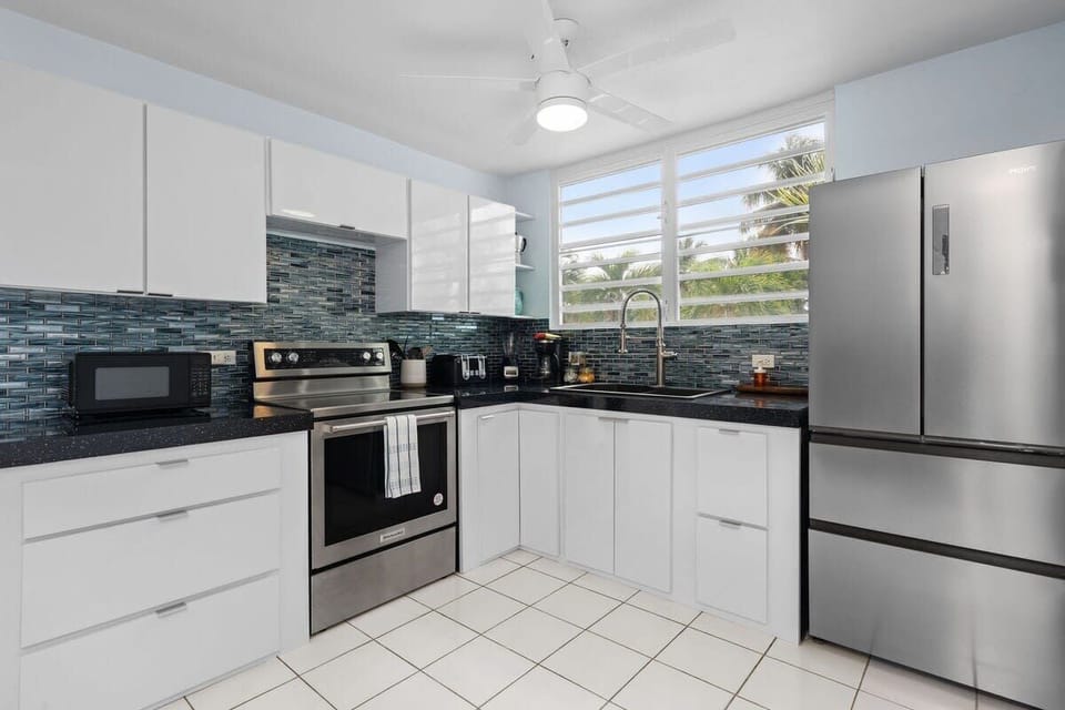 The kitchen features a stove, oven, microwave, full-size refrigerator and freezer, coffee maker, toaster, and a blender.