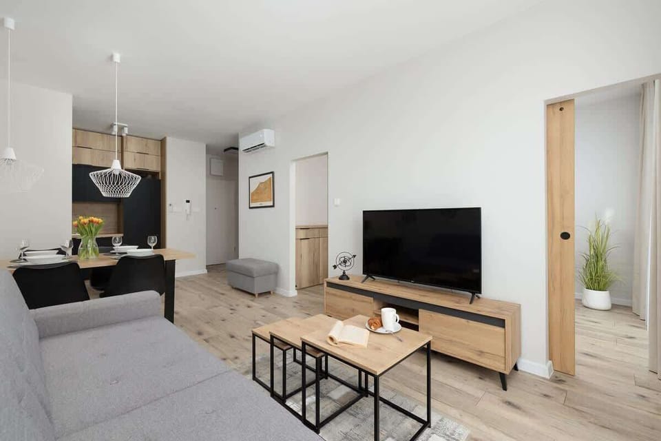 A different angle of the living room, emphasizing the seamless connection to the dining and kitchen area.

