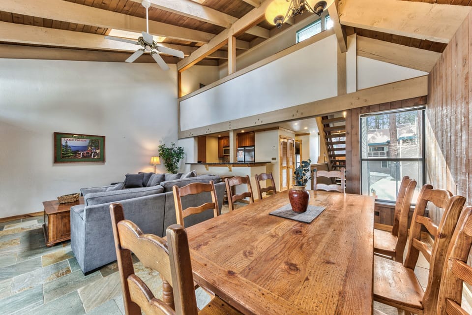 Gather around this rustic dining table beneath soaring wood beams, where mountain memories are made over shared meals and laughter.