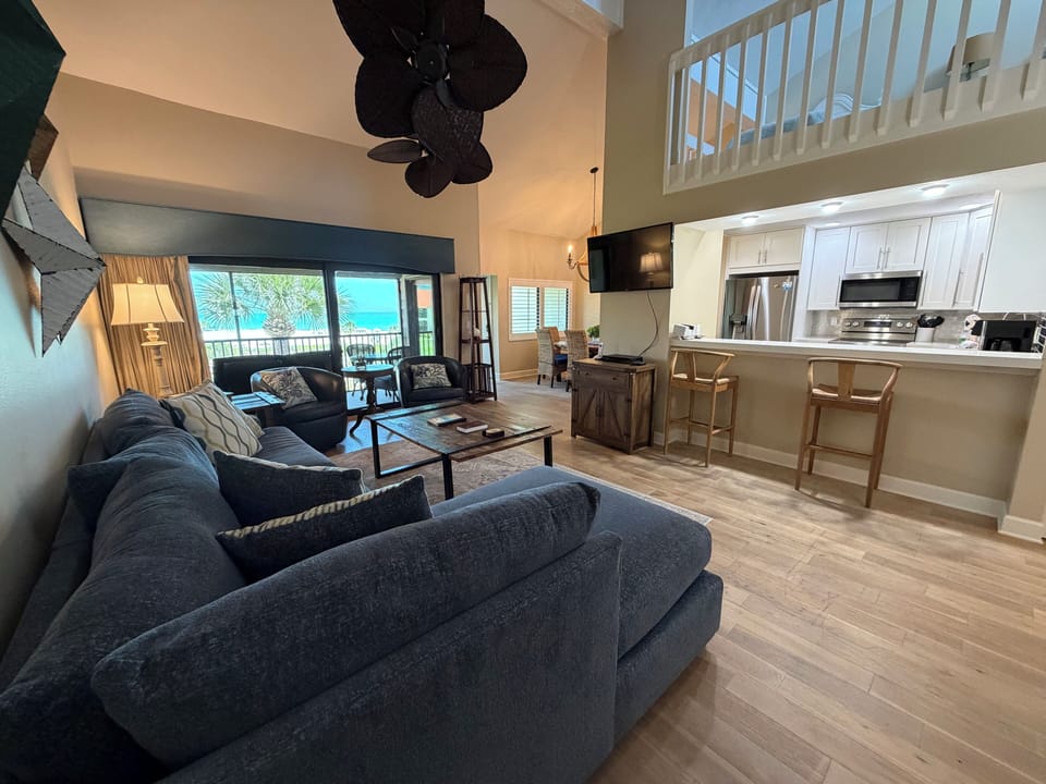 Unwind in your spacious open-concept retreat with soaring ceilings, plush seating, and direct ocean views. The fully equipped kitchen awaits your coastal culinary adventures.
