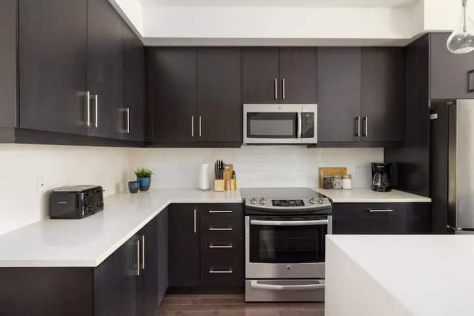 Modern kitchen with plenty of space and stainless steel appliances.