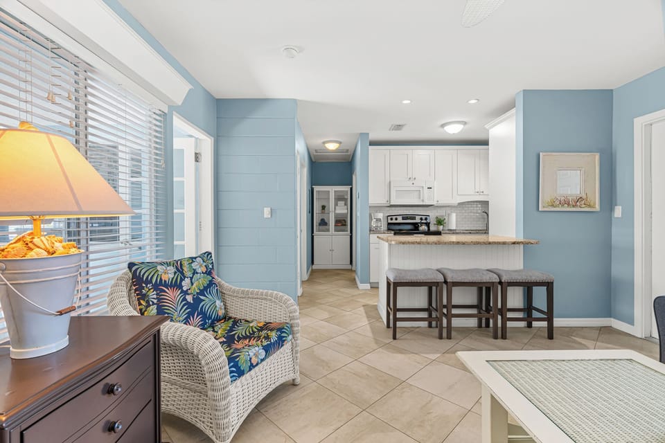 Unwind in your bright living space with patio access, beach views, and kitchen island seating.