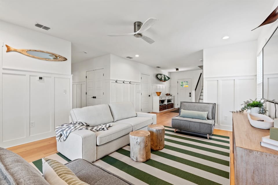 1st floor living room with 2 foldout twin beds and sliding door to the backyard. (1)