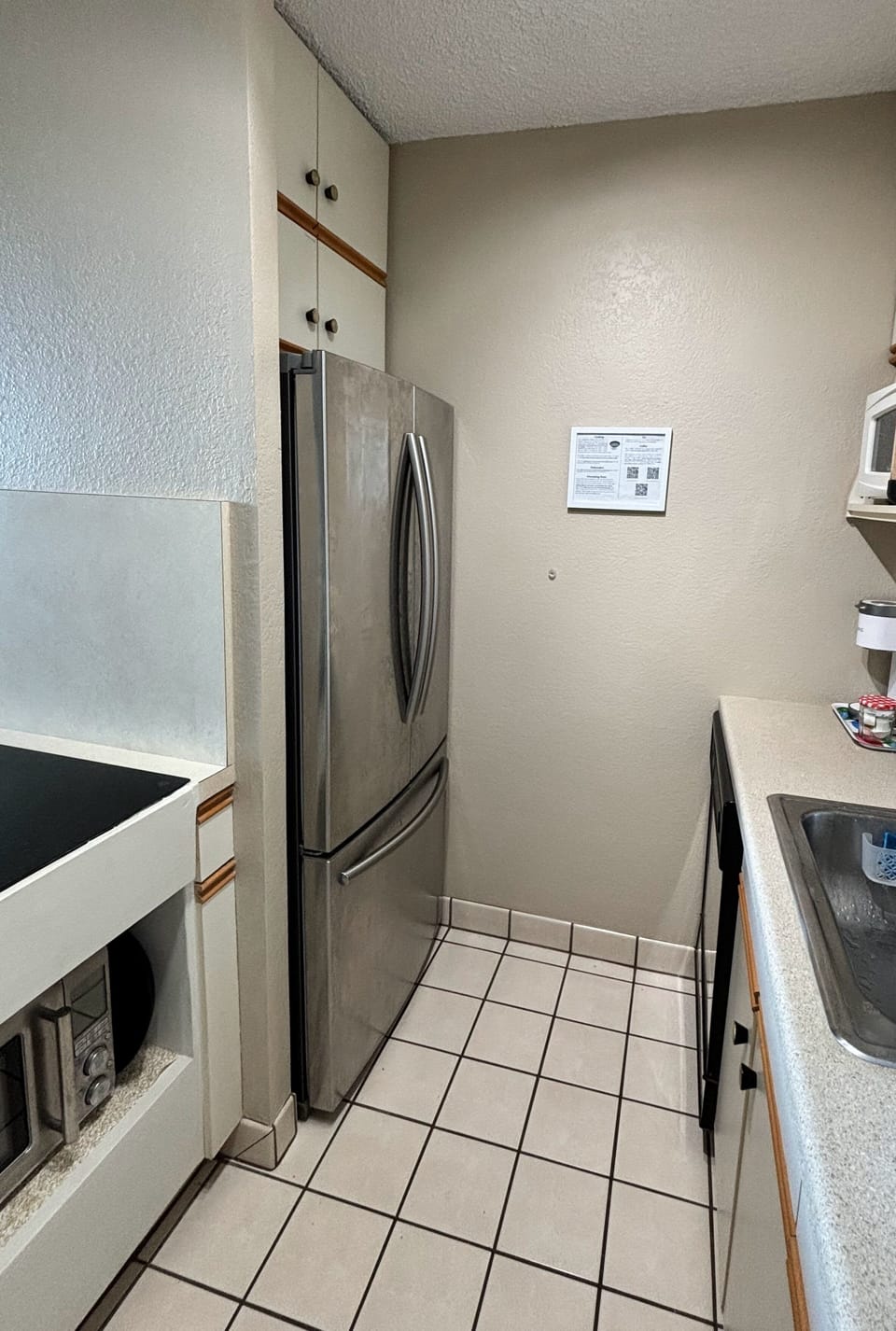 The kitchen has a large refrigerator, dishwasher, microwave, and combi oven.