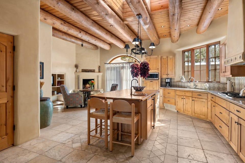 The chef-style kitchen includes a fireside corner with table and comfy chairs.