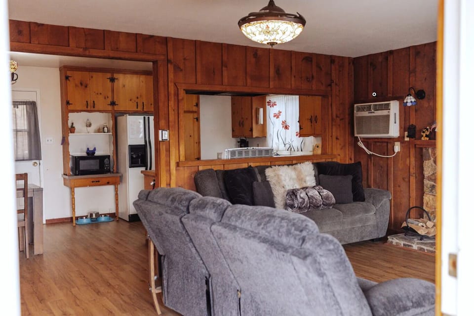 Living room. Has couch, reclinable love seat, fireplace, smart TV and cable.