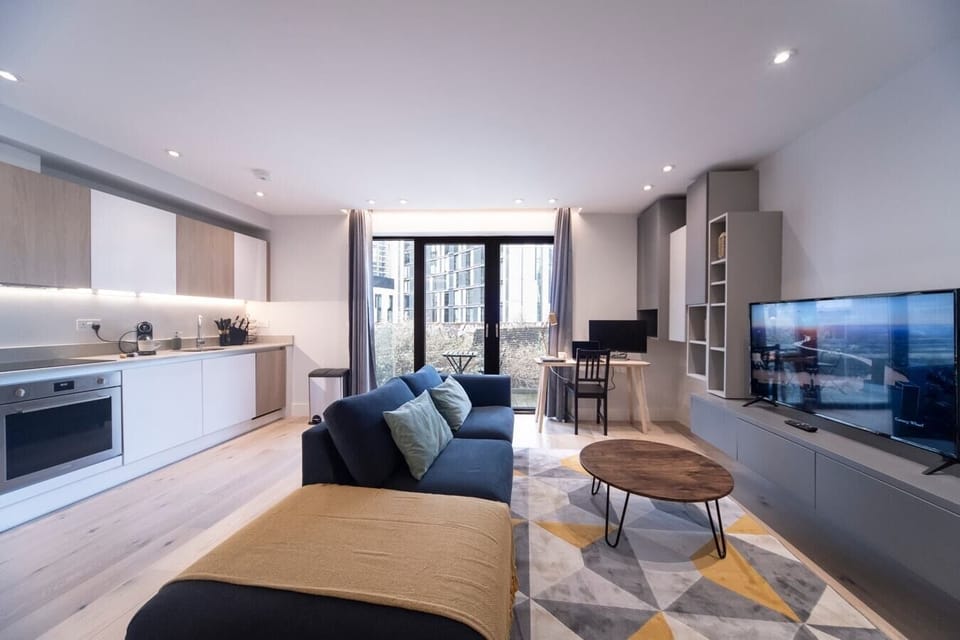 Integrated living, bedroom, and kitchen spaces in an open layout.