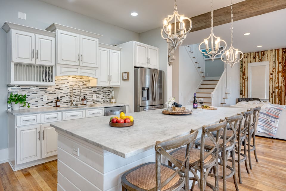 Large island in the kitchen with 5 barstool seats.