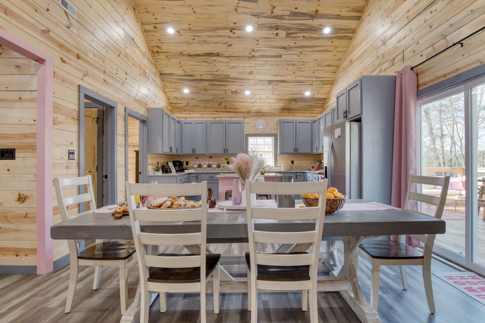 Dining space with rustic wood details, pink accents, and room to gather after a day out.