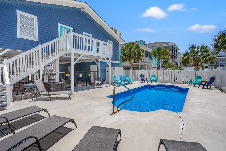 Palm trees shade the private pool at The Blue Pearl, a 4-bedroom Cherry Grove rental in North Myrtle Beach