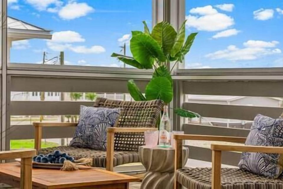 Two deep seat captains chairs with their own side table, await you on the porch.