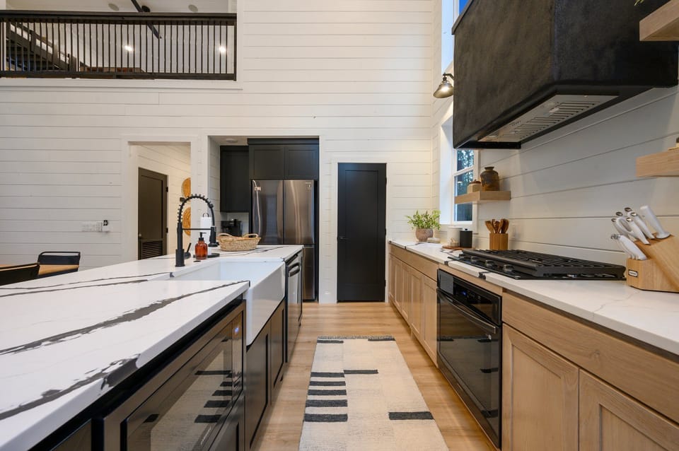 Swinging around the island you'll enter the galley which holds the microwave, stove, oven and dishwasher.