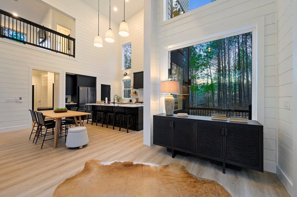 To the right you can begin entering the kitchen while you pass more beautiful forest views framed by the windows.