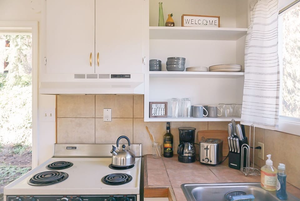 Kitchen is fully equipped with essential cooking utensils. 