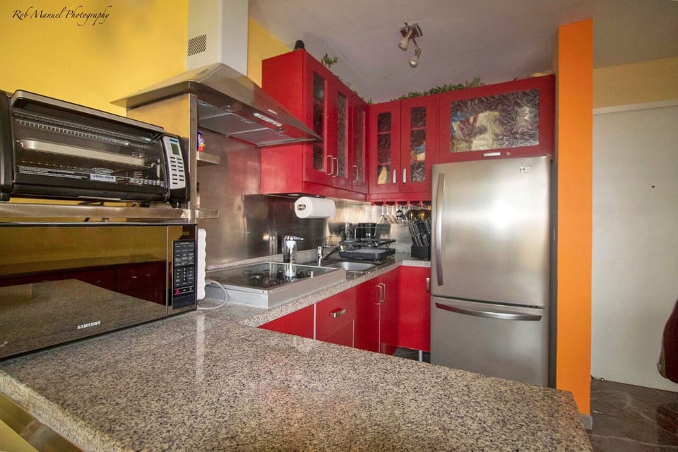 Kitchen with fridge, stove, microwave, toaster oven, blender, water dispenser