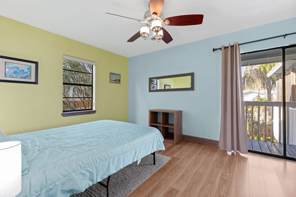 Bedroom 2 with direct balcony access to the pool area