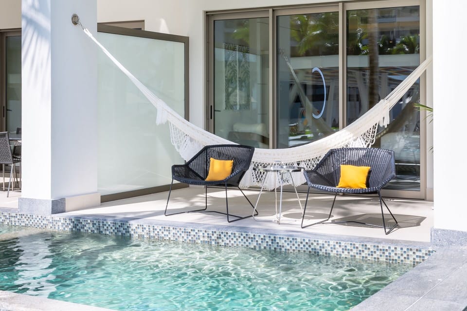 Garza Blanca Cancun: private terrace with hammock, seating, and plunge pool.