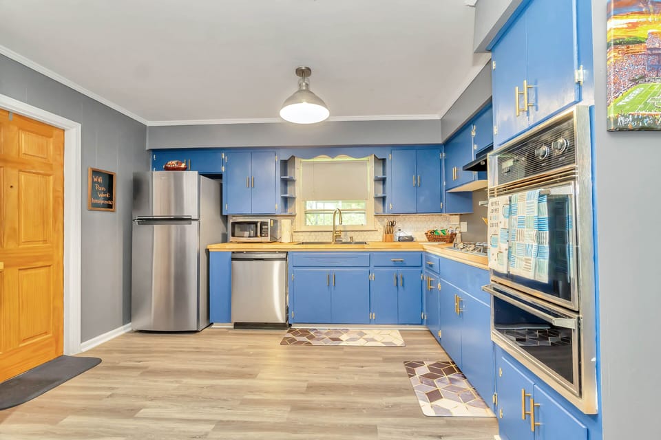 Kitchen with refrigerator, dishwasher & oven.