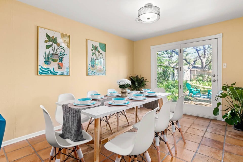 Savor your meals in the sunlit dining room, offering a delightful view of the backyard for a truly enchanting dining experience.