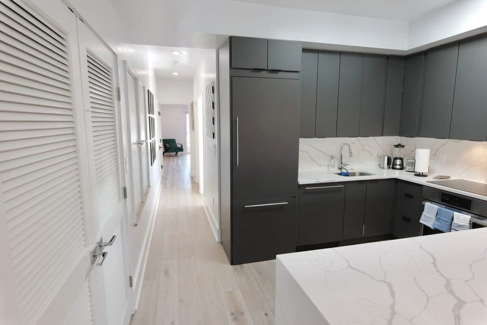 Behind the kitchen, you will find the bedrooms & bathrooms at the end of the hallway, as well as the washer & dryer in the hallway closets
