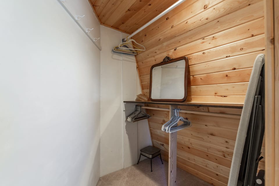 This cozy upstairs closet space offers plenty of room to unpack and stay organized during your stay. With hanging space, shelves, and a mirror, it's a convenient spot to settle in and store your gear after a day of adventure.
