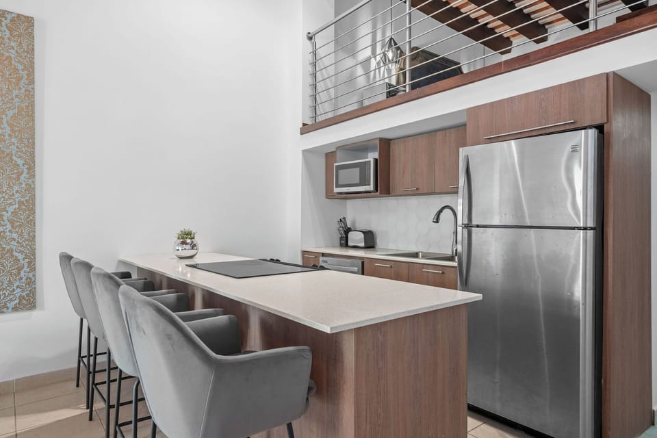 Prepare delicious meals in the fully equipped kitchen of Azucena Mezzanine, complete with modern appliances and ample counter space for meal preparation.