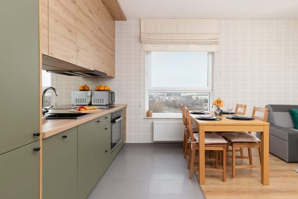 A different perspective of the open-plan kitchen and dining space, showcasing its functional layout and natural lighting.

