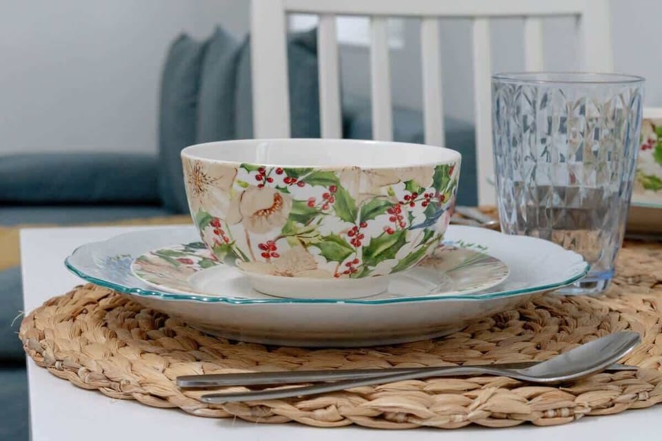 A close-up of a beautifully arranged plate, featuring floral patterns and rustic woven placemats for a cozy dining experience.


